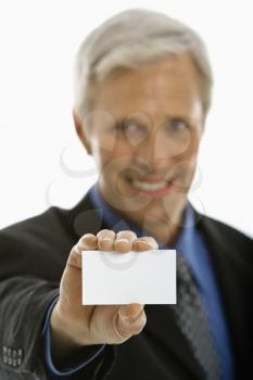 Royalty Free Photo of a Businessman Holding Out a Business Card