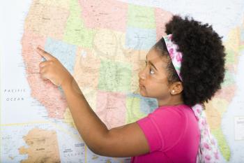 Royalty Free Photo of a Girl Pointing on a Map of the United States