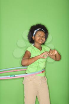 Royalty Free Photo of a Girl Hula Hooping and Smiling