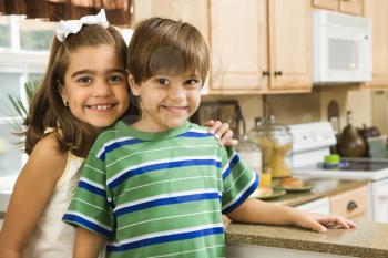 Royalty Free Photo of Children in a Kitchen Smiling