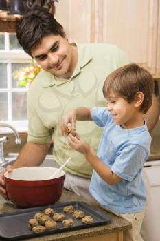 Royalty Free Photo of a Father and Son in the Kitchen Making Cookies