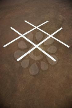 Royalty Free Photo of a Tic Tac Toe Game on Playground Concrete