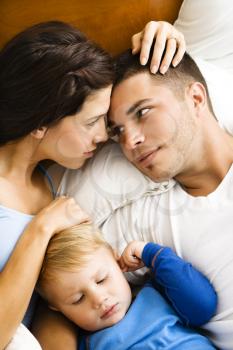 Royalty Free Photo of a Family Cuddling in Bed Together