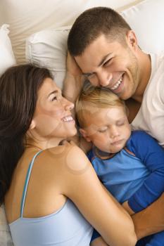 Royalty Free Photo of a Family Cuddling in Bed Together