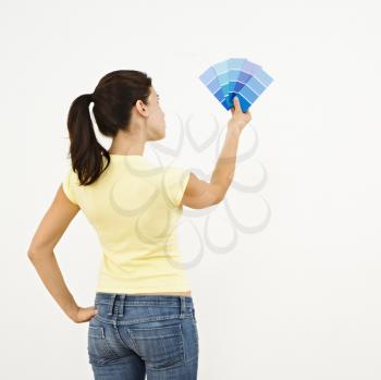 Royalty Free Photo of a Woman Trying to Choose a Paint Color