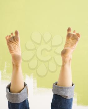 Royalty Free Photo of a Woman's Legs and Dirty Feet Sticking Up in the Air