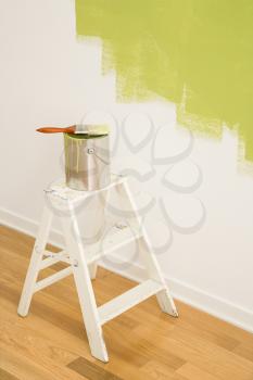 Royalty Free Photo of a Paintbrush on a Paint Can on Top of a Step Ladder