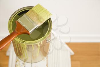 Royalty Free Photo of a Paintbrush on a Paint Can on Top of a Step Ladder