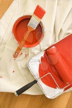 Royalty Free Photo of Painting Supplies on a Drop Cloth on a Wood Floor
