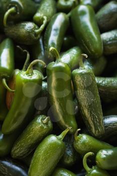 Royalty Free Photo of a Pile of Green Jalapeno Peppers at a Produce Market
