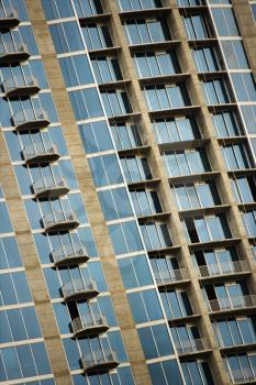 Royalty Free Photo of an Exterior of a High Rise Building With Mirrored Windows and Balconies