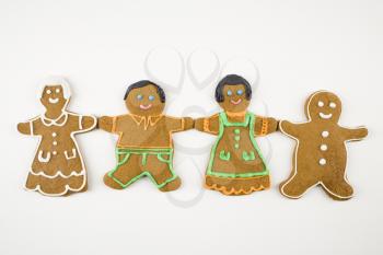 Royalty Free Photo of Four Gingerbread Cookies Holding Hands