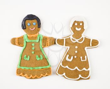 Two female gingerbread cookies holding hands.