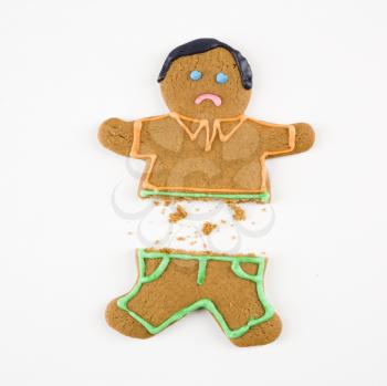 Royalty Free Photo of a Frowning Gingerbread Cookie Broken in Half