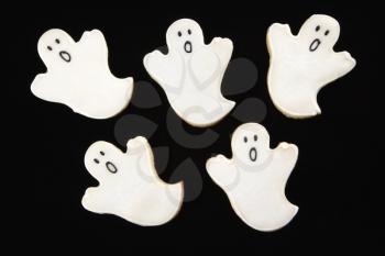 Royalty Free Photo of Five Sugar Cookies in the Shape of Ghosts With Decorative Icing