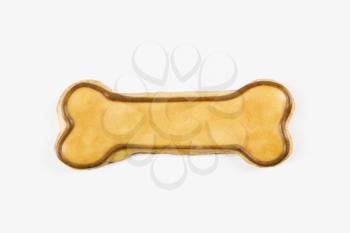 Sugar cookie in shape of dog bone with decorative icing.