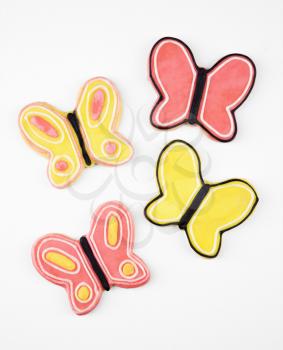Four butterfly sugar cookies with decorative icing.