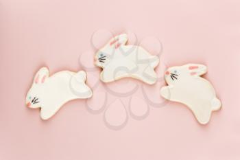 Three bunny shaped sugar cookies with decorative icing.