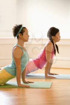 Royalty Free Photo of Two Women in Yoga Class Doing an Upward Cobra Pose