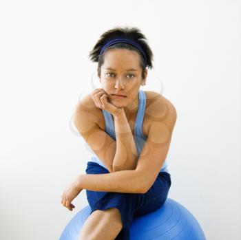 Royalty Free Photo of a Woman Sitting on a Fitness Balance Ball