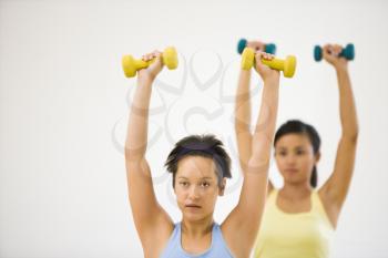 Royalty Free Photo of Young Women Lifting Dumbbell Weights