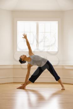Royalty Free Photo of a Young Woman Doing a Yoga Triangle Pose