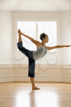 Royalty Free Photo of a Woman Doing a Yoga King Dancer Pose