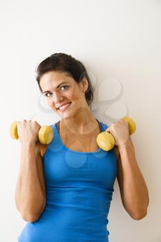 Royalty Free Photo of a Woman Holding Weights and Smiling