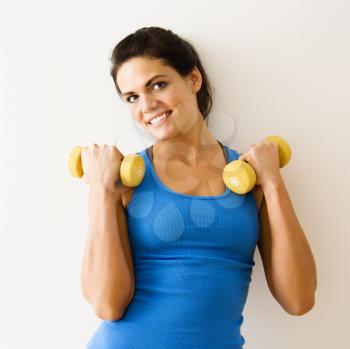 Royalty Free Photo of a Woman Holding Hand Weights and Smiling