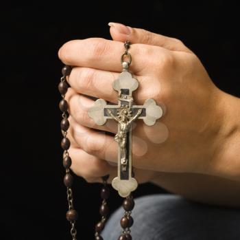 Royalty Free Photo of a Woman Holding a Rosary With a Crucifix