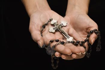 Royalty Free Photo of Woman's Hands Palm Up Holding a Rosary With a Crucifix