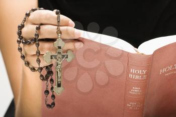 Royalty Free Photo of a Woman Holding a Holy Bible and Rosary in Her Hand