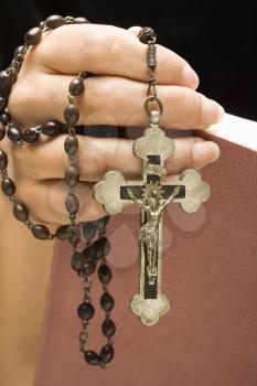Royalty Free Photo of a Woman Holding a Holy Bible and Rosary in Her Hand