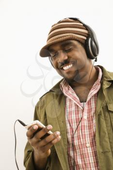 Royalty Free Photo of a Man Wearing a Knit Hat and Listening to an Mp3 Player  Smiling