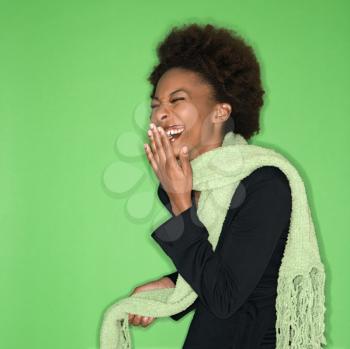 Royalty Free Photo of a Woman Wearing a Scarf and Laughing
