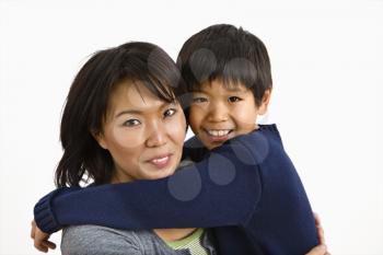 Royalty Free Photo of an Asian Mother and Son Hugging and Smiling