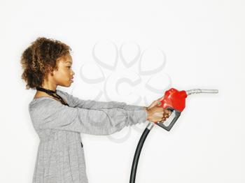 Royalty Free Photo of a Woman Holding Out a Gas Pump