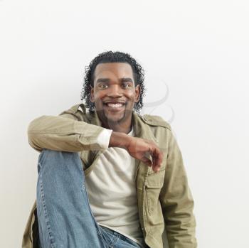 Royalty Free Photo of a Portrait of a Man Sitting Smiling