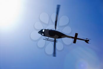 Royalty Free Photo of a Helicopter Flying Trough the Sky