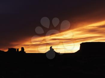 Royalty Free Photo of a Sunset Landscape of Mesas in Monument Valley 