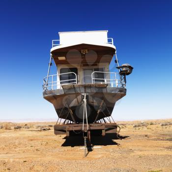 Landscape of houseboat sitting in the middle of the desert in rural Arizona, United States.