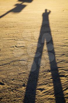 Royalty Free Photo of a Shadow of a Man on Dirt at Sundown