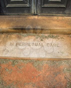 Royalty Free Photo of a Mausoleum Entrance in a Graveyard With Words In Perpetual Care