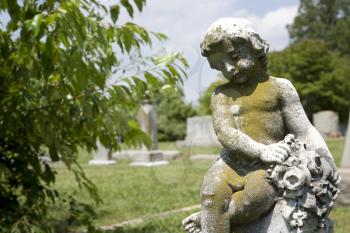 Graveyard scenic with cherub statue.