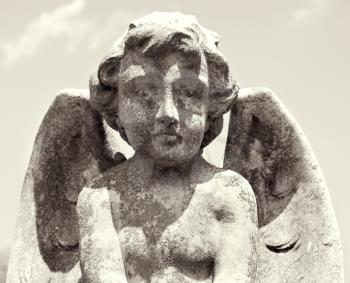 Royalty Free Photo of a Statue of a Cherub in a Graveyard