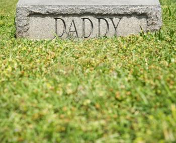 Royalty Free Photo of a Gravestone Marker With the Word 'Daddy' On It