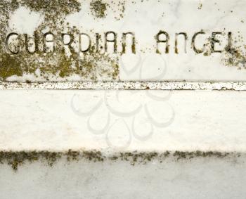 Royalty Free Photo of a Gravestone With Words 'Guardian Angel' On It