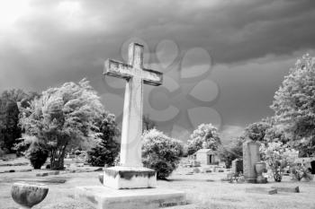 Royalty Free Photo of an Infrared Graveyard Scene With a Cross and Gravestones