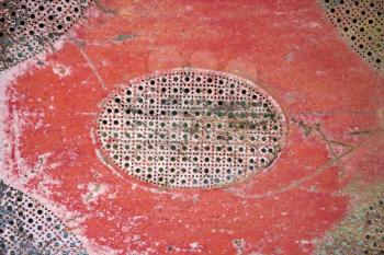 Royalty Free Photo of an Old Red Patterned Piece of Metal