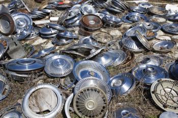 Royalty Free Photo of Old Metal Hubcaps Strewn Across the Ground